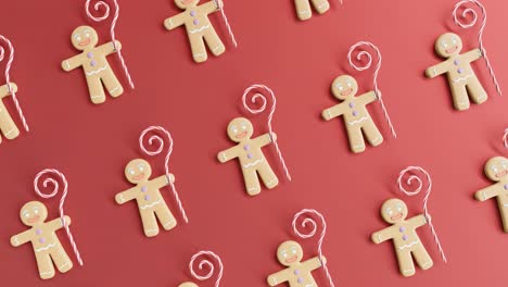 gingerbread men and candy canes on a red background