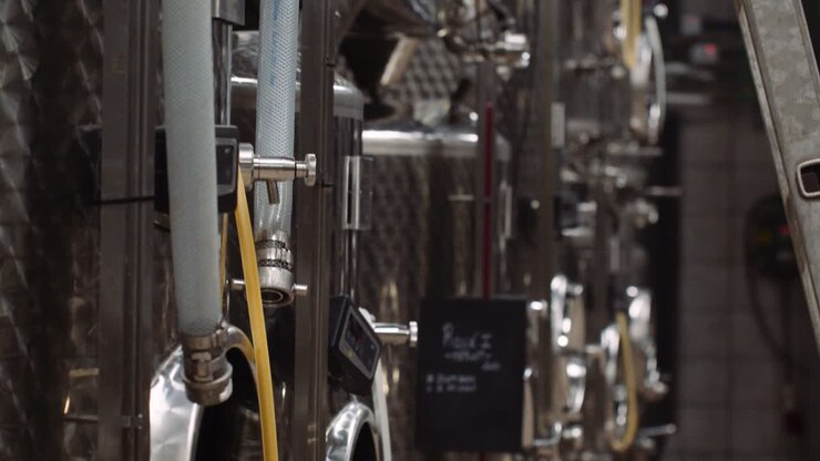 Shallow focus tilt-up shot of wine tanks used in the wine-making process