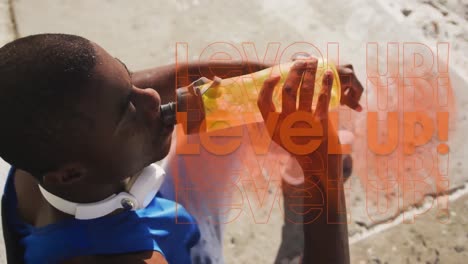 animation of level up text over african american sportsman drinking water