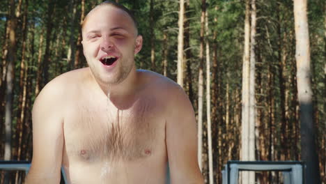 happy vacation a man enjoys relaxing by the pool pulling out of the water slow motion