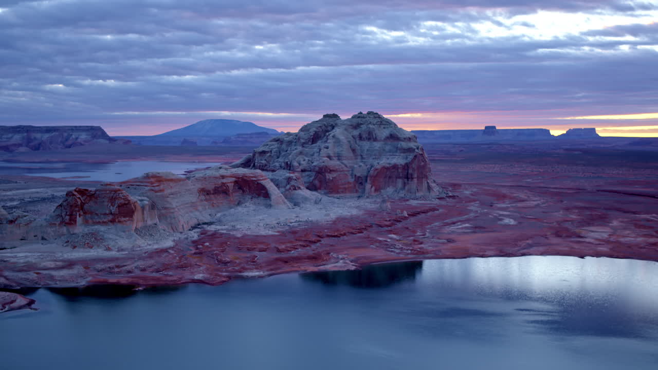 A cinematic aerial pass navigates through Glen Canyon’s sculpted landscape, highlighting the contrast between rock and water.