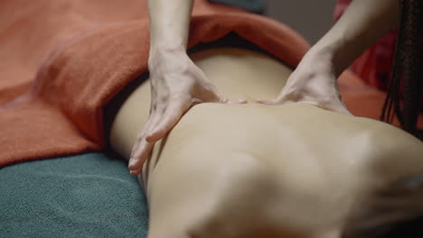 woman receiving a back massage at a spa