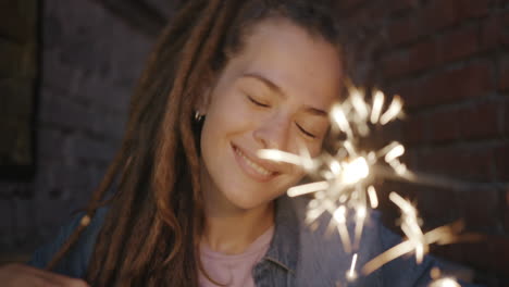 smiling woman holding a sparkler