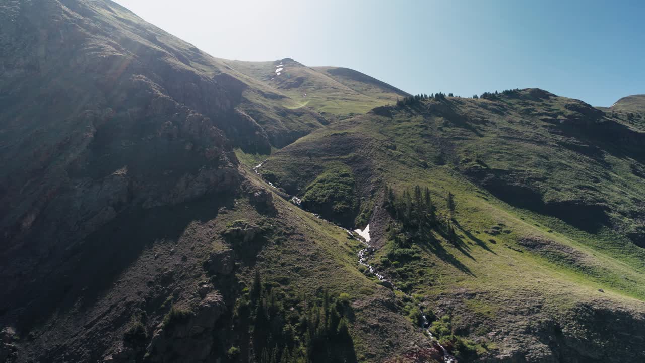 Tracking aerial looking up at the San Juan mountains.