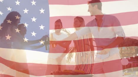 Animation-of-american-flag-waving-over-group-of-friends-making-toast-with-beer-bottles-on-beach