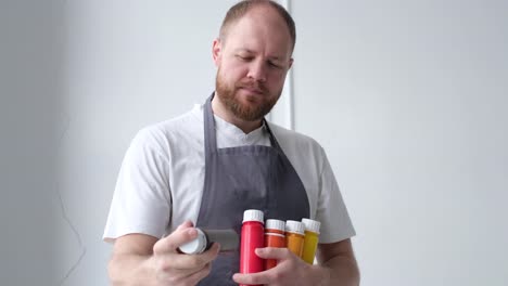 artist holding colorful paint bottles