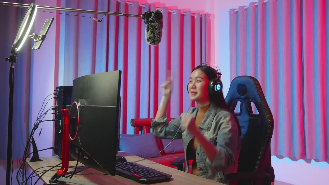 Young Streamer Girl Win While Playing Video Game On Computer And Talking To Mobile Phone