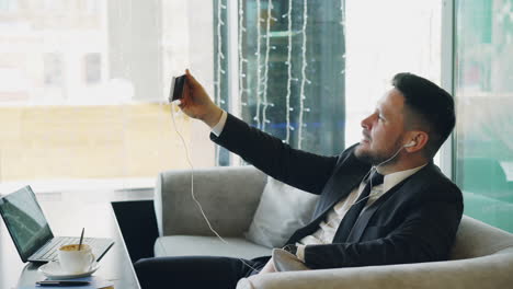 businessman taking a selfie in a coffee shop