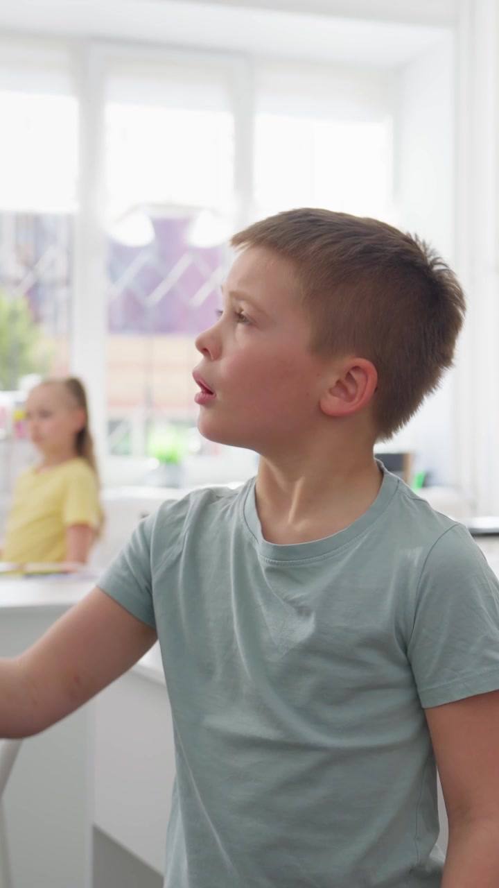 Curious Young Boy Observing in a Bright Classroom