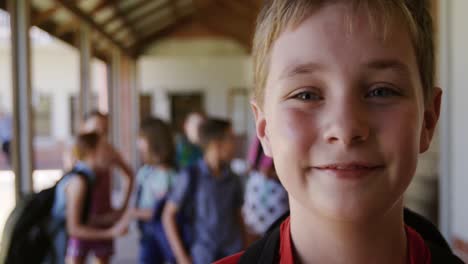 Boy-smiling-in-the-school-corridor