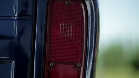Close-up-shot-of-red-lighting-brake-light-of-pick-up-car-and-driving-away