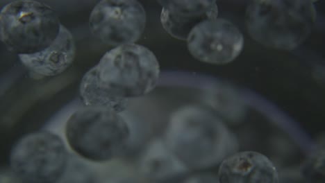 spinning-blueberries-suspended-in-water,-amazing-shot-of-fresh-blue-berries-being-washed