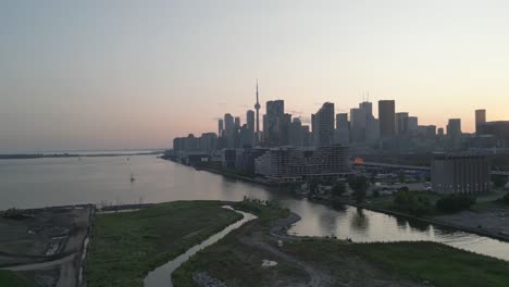 Stunning-4K-cinematic-footage-of-Toronto-cityscape-bathed-in-the-golden-hues-of-sunset,-highlighting-the-city's-dynamic-architecture-and-bustling-streets