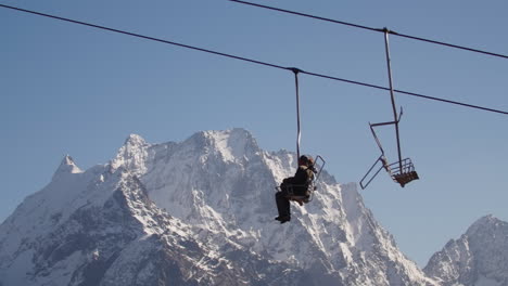 ski lift in snowy mountains