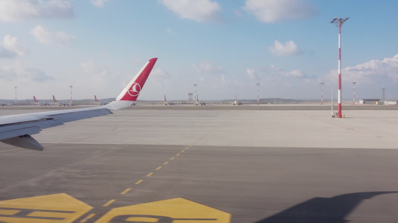 View of a Turkish Airlines passenger plane wing as it taxis along the runway in Istanbul