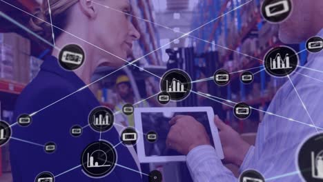 red de iconos digitales sobre un supervisor caucásico masculino y femenino usando una tableta digital en el almacén