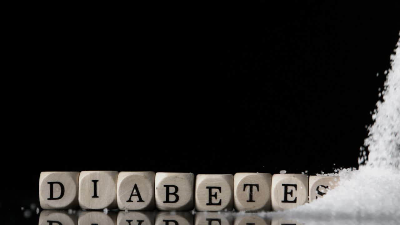 Sukker hældes ud over terninger, der staver diabetes.