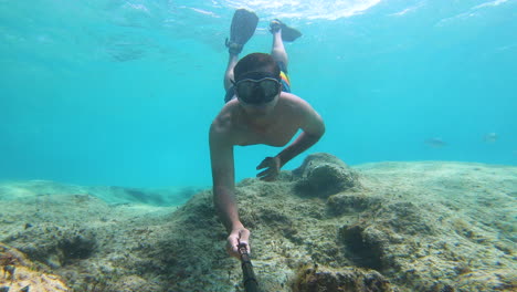 Dive-and-swim-on-the-surface-of-the-blue-ocean-with-stick-on-action-camera