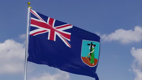 flag of montserrat moving in the wind with a clear blue sky in the background, clouds slowly moving, flagpole, slow motion