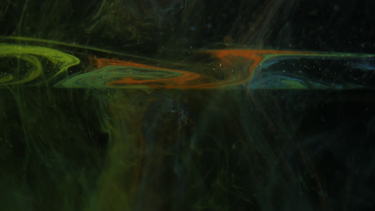 Unusual visual effect. Multi-colored fog on a black background. VFX element