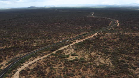 Asphalt-Road-With-Cars-In-The-Midst-Of-Vast-Wilderness-In-Omo-Valley,-Ethiopia