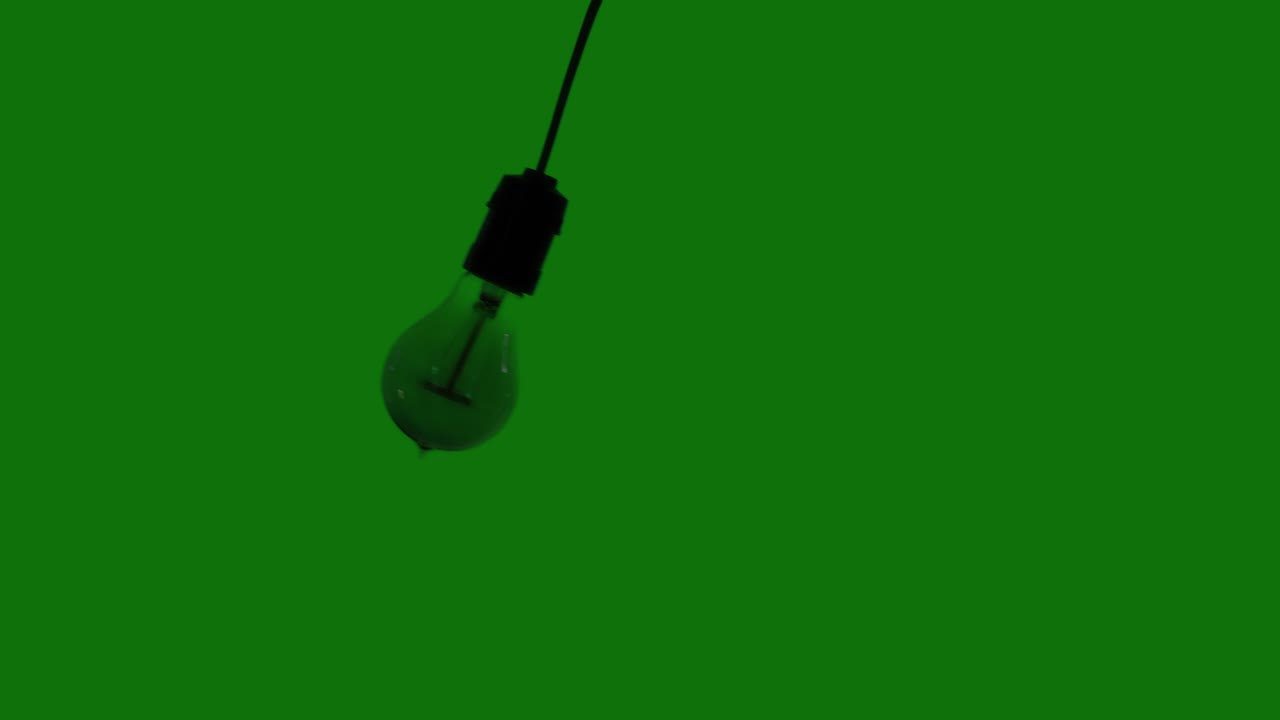 Light bulb swaying to and fro in studio | Premium Stock Video Footage