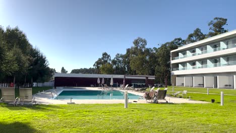 Área-De-Piscina-Exterior-Del-Hotel,-Oasis-De-Tranquilidad-Perfectamente-Integrado-En-El-Exuberante-Entorno.