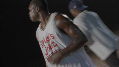 three men play basketball on an indoor court 2