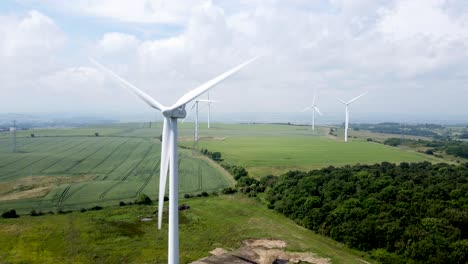 Wind-Turbine-rotating-turning-in-field-on-a-cloudy-summer-day