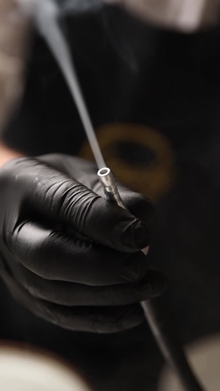 Smoking Tube in Hand with Black Gloves