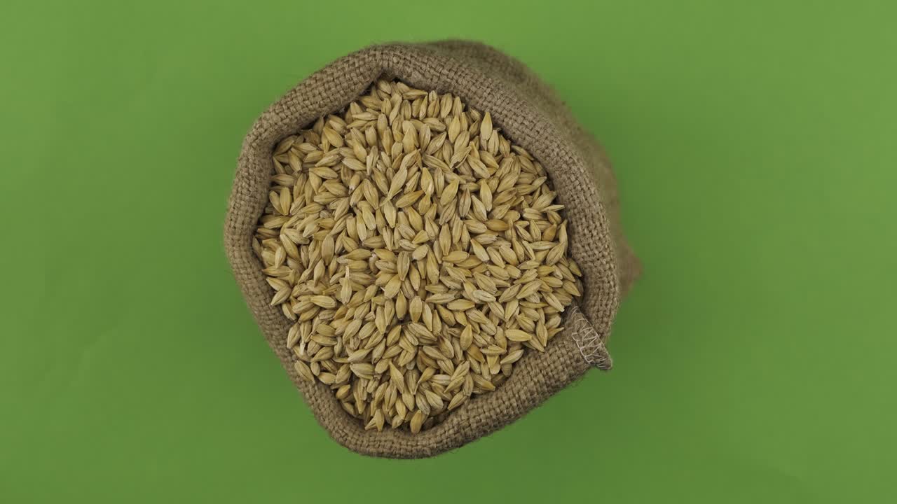 Rotation of a full sack of barley grain. Top view. Isolated
