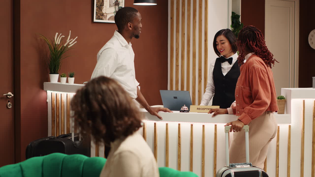 Receptionist handing executives room key