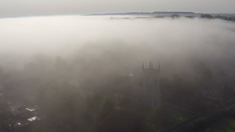 drone shot orbiting islip church in mist 09