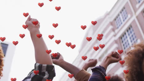 activists standing on urban street, raising fists in activism, showing floating hearts overlay