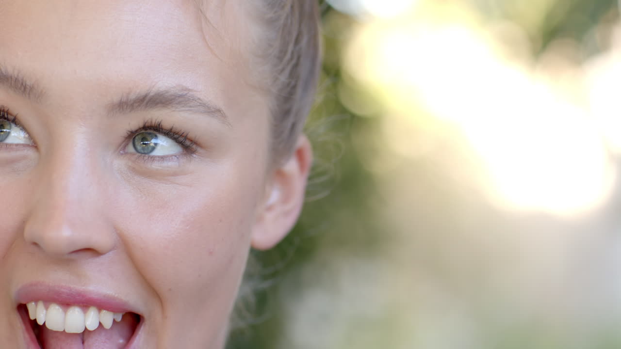 Woman outdoors making playful expression, enjoying sunny day by pool, copy space