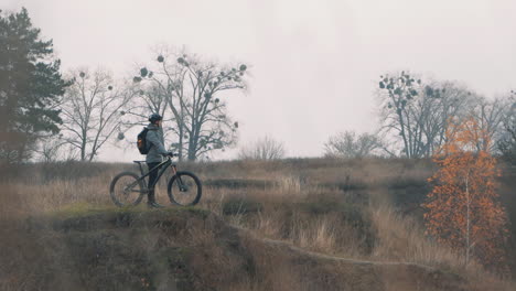 athlete man resting from riding a mountain bike in the hill