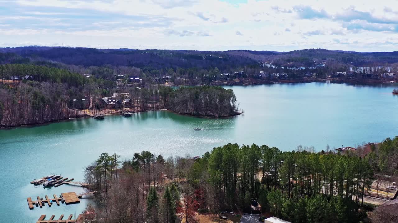 Drone targets pontoon boat on the turquoise blue waters of Lake Kiwi in Seneca, SC.