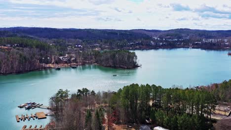 drone targets pontoon boat on the turquoise blue waters of lake kiwi in seneca, sc.