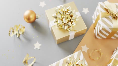 video of christmas gifts with christmas decoration on grey background