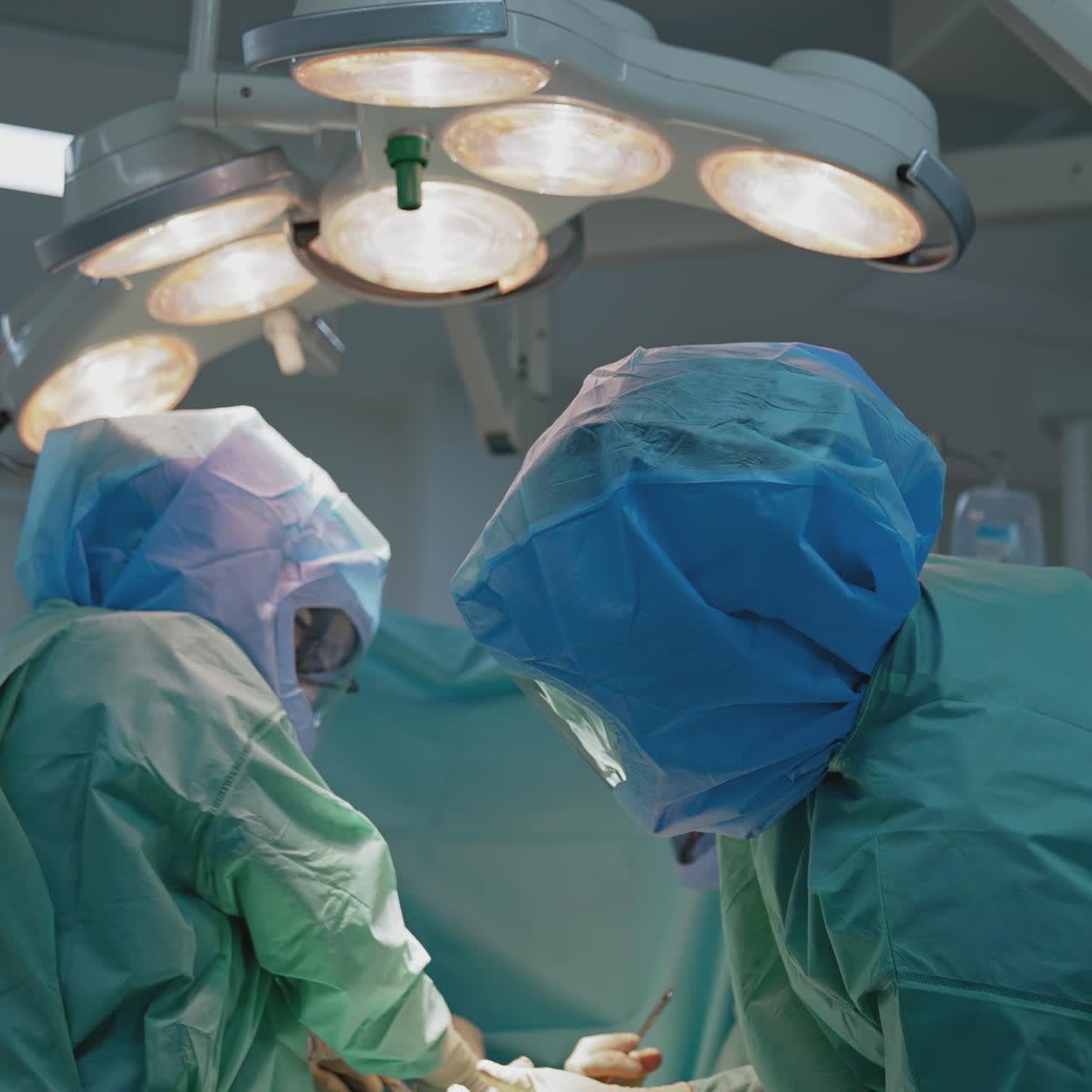 In surgery. Medical team performing operation in hospital operating theater. Working with surgical instruments