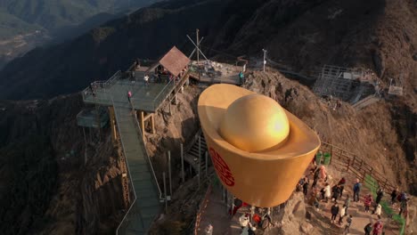 Fly-over-the-scenic-spot-on-top-of-the-mountain-with-tourists-walking-on-glass-bridge