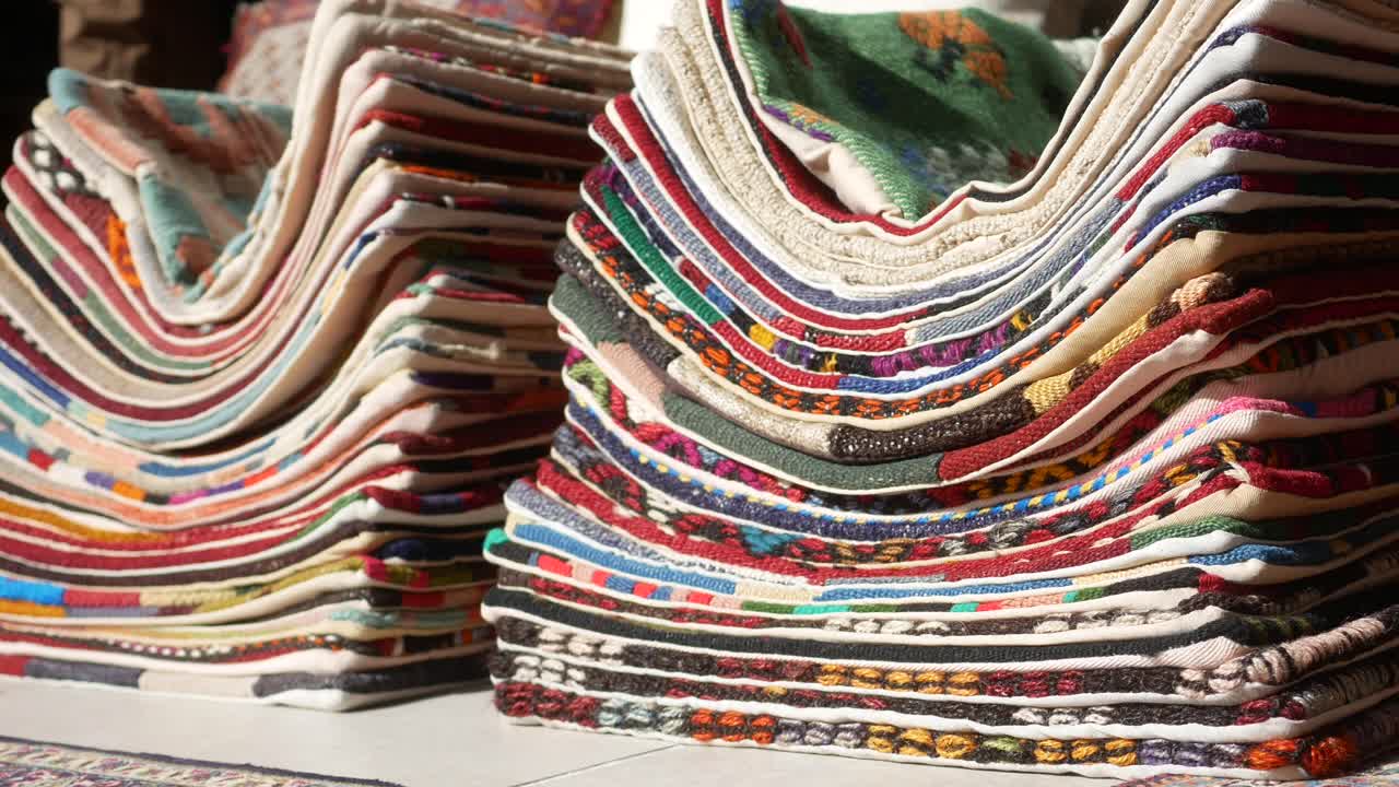 Stacked Colorful Handmade Rugs and Pillows for Sale