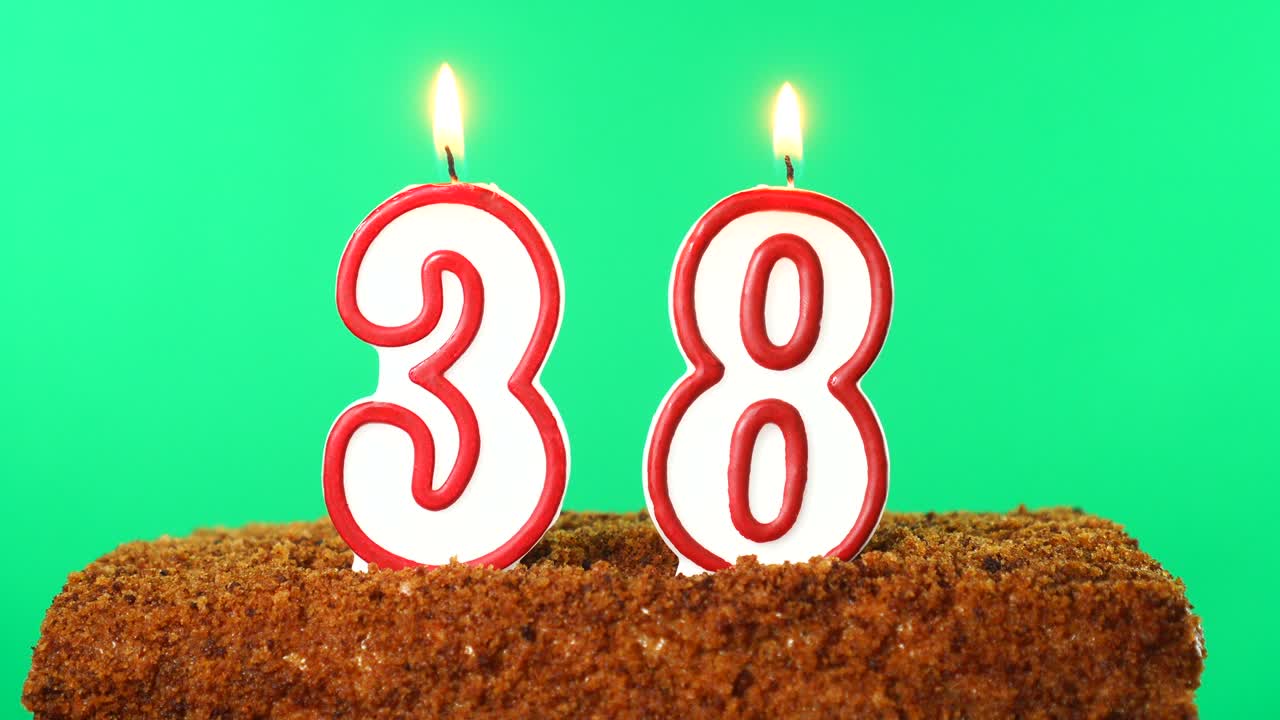 Cake with the number 38 lighted candle. Chroma key. Green Screen. Isolated