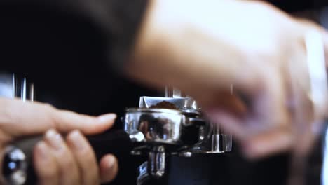 Barista's-Hand-in-Slow-Motion-Preparing-Ground-Coffee-with-Tamper-and-Portafilter