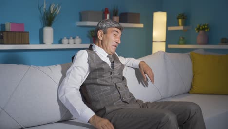 the old man watching tv laughs. comedy.