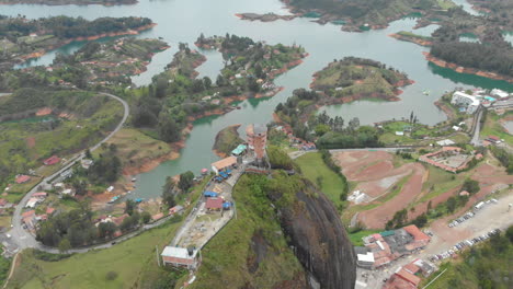 flying above a large granite rock called the rock of guatape in antioquia, colombia - aerial drone shot