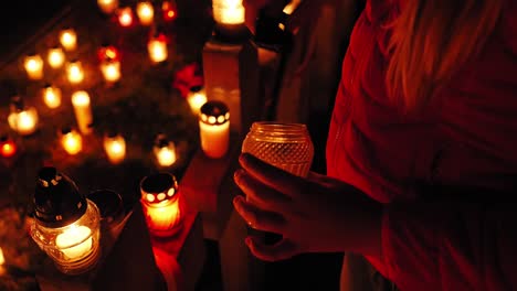 graveyard, candles are lit on the grave at night