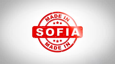 hecho en sofia firmado estampado texto animación de sello de madera. tinta roja en papel blanco limpio fondo de superficie con fondo matte verde incluido.