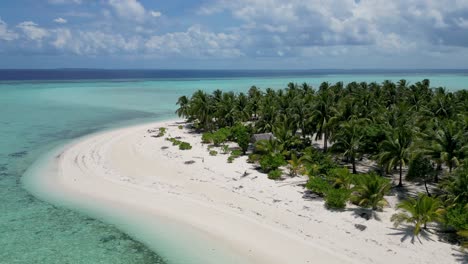 Onok-Island-Balabac,-aerial-parallax-of-white-sandy-beach-and-hut-in-palm-tree