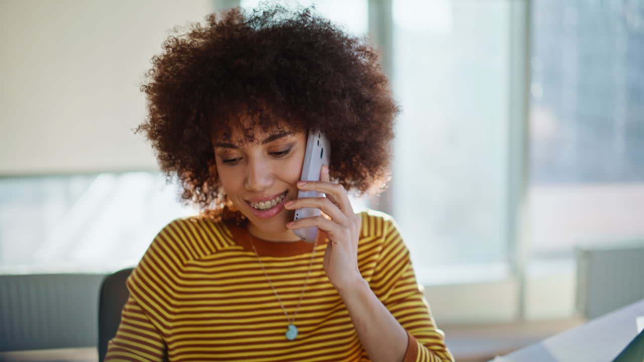 businesswoman calling telephone sitting with unknown colleague closeup